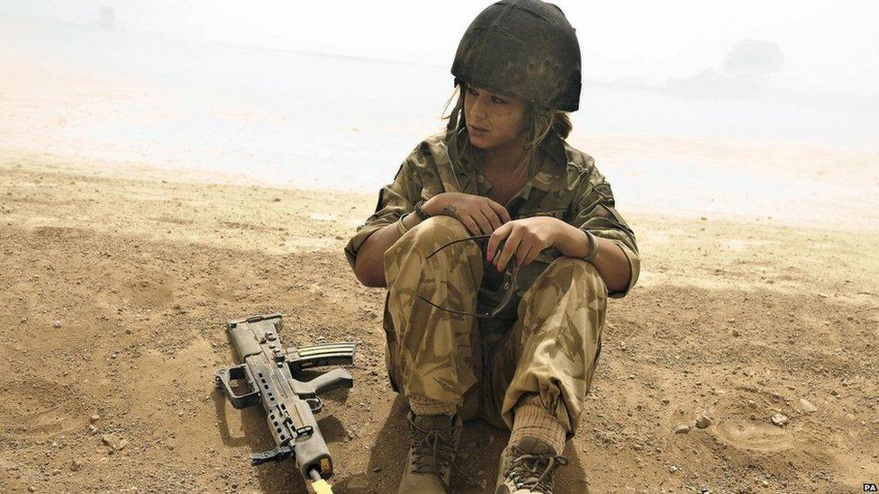 Cheryl Cole sitting down in the desert