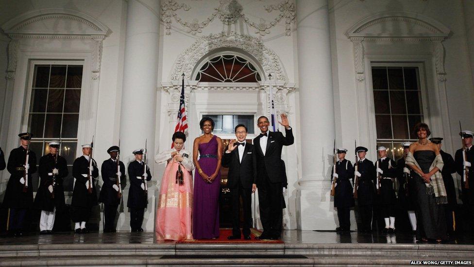 South Korean first lady Kim Yoon-ok, US first lady Michele Obama, South Korean President Lee Myung-bak and US President Barack Obama pose for photographs on the North Portico of the White House before attending a state dinner in Washington