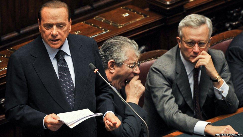 Italian Prime Minister Silvio Berlusconi (L) gives a speech next to Northern League leader Umberto Bossi (C) and Finance Minister Giulio Tremonti, at Italy's Chamber of Deputies