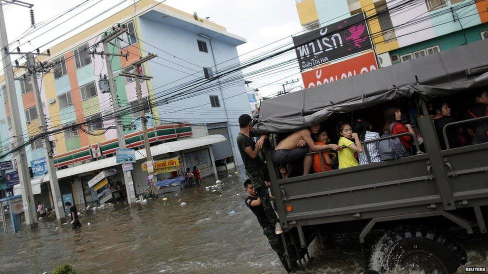 Truck carrying people away from floods