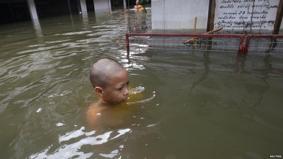 Young boy wades through the water