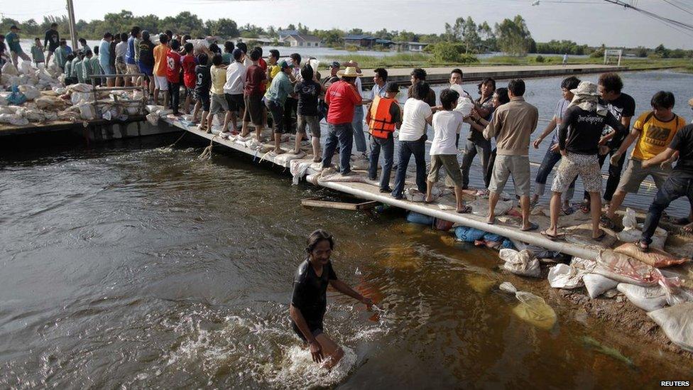 People carrying sandbags