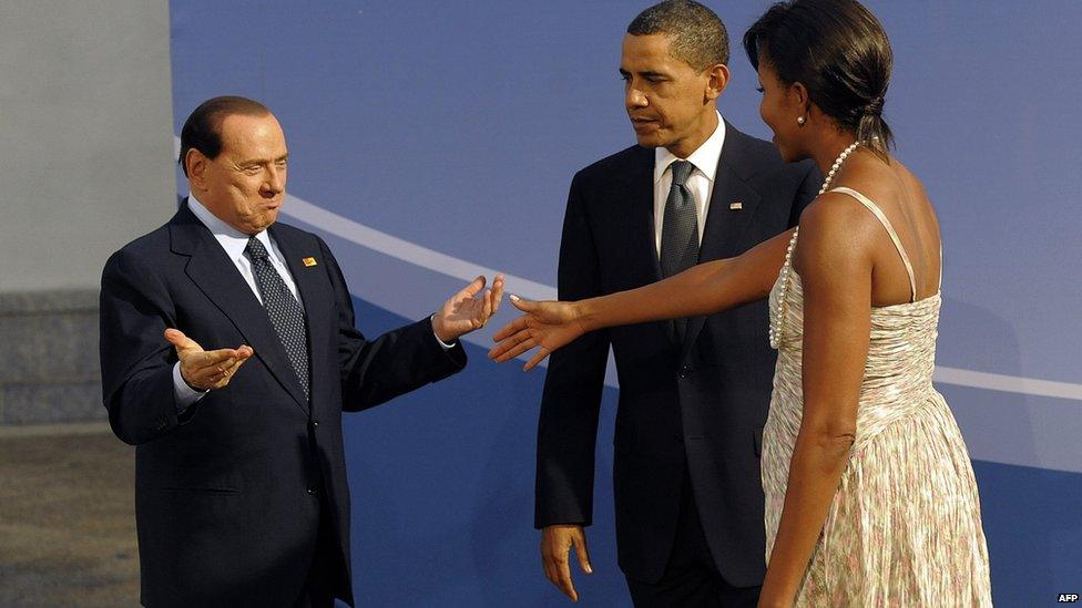 Silvio Berlusconi (left) gestures after Michelle Obama tries to shake his hand instead of letting him kiss hers at a dinner in Pittsburgh, 24 September 2009, while Barack Obama looks on