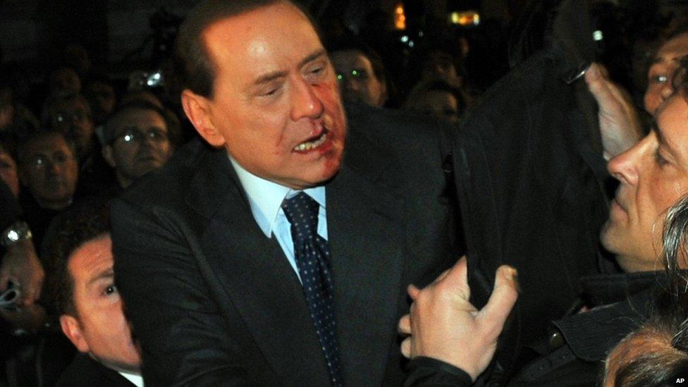 Silvio Berlusconi is rushed to safety after an attack in Milan, 13 December 2009