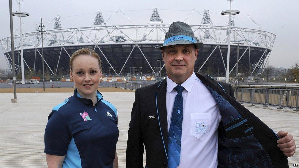 Two of the technical officials for the London Games show off their uniform in front of the Olympic Stadium.