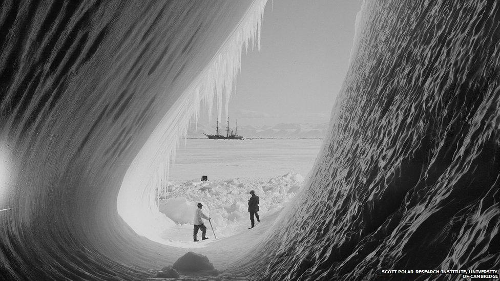 View through ice cave to distant ship