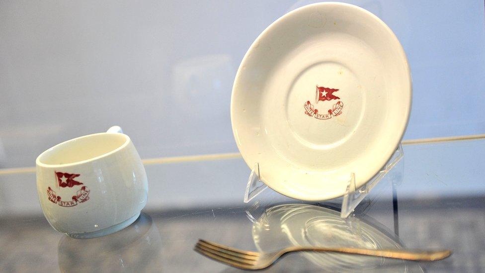 cup, saucer and fork