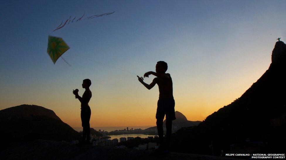 Two children flying kites