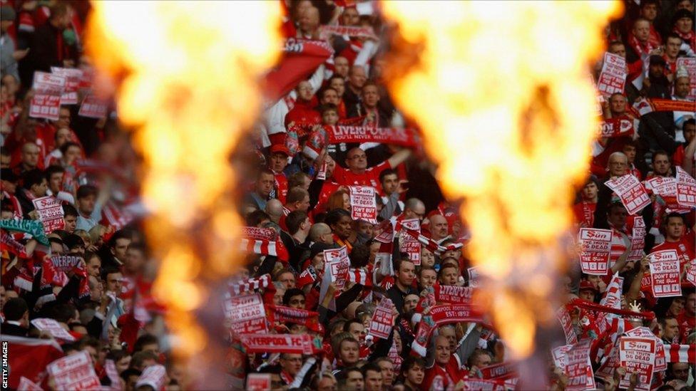 Liverpool fans hold banners protesting against The Sun newspaper prior to their Carling Cup Final match against Cardiff City at Wembley Stadium