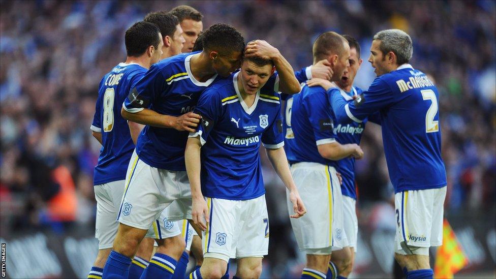 Joe Mason of Cardiff City (centre) celebrates with team mates after he scores their first goal