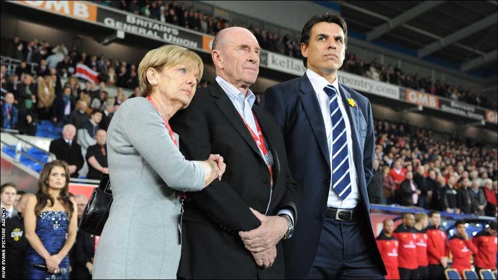 Wales manager Chris Coleman looks on during the national anthems with Gary Speed's parents Roger and Carol