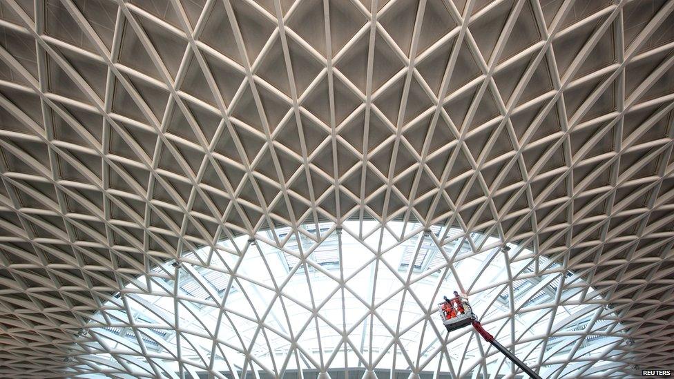 The new roof over King's Cross is made of white steel beams, in a tessellated pattern of triangles. In the centre of the dome, the covering turns to glass and light flows in.