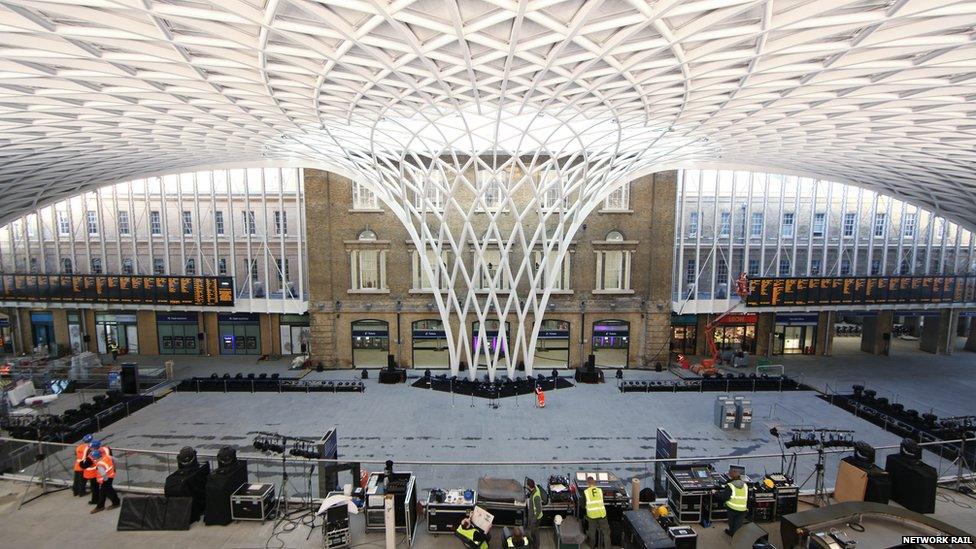 The original station building, photographed from inside the new concourse structure. The original yellow brickwork is untouched, whilst the new meshed roof arcs down and touches the floor right in front of the station building.