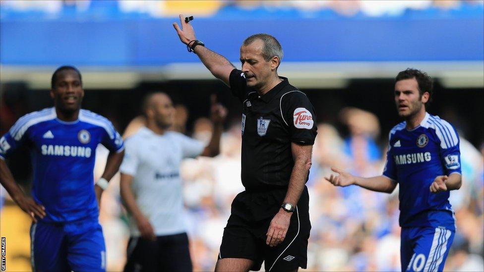 Referee Martin Atkinson waves play on during the match between Chelsea and Tottenham Hotspur at Stamford Bridge