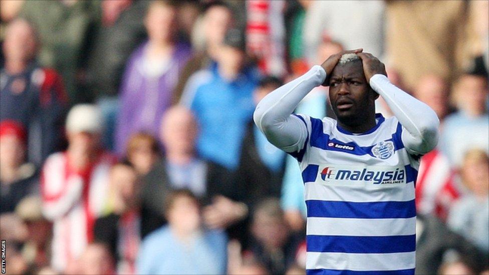 Queens Park Rangers' Djibril Cisse stands dejected after being given a red card