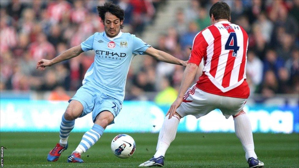 Manchester City's David Silva and Stoke City's Robert Huth (right) battle for the ball