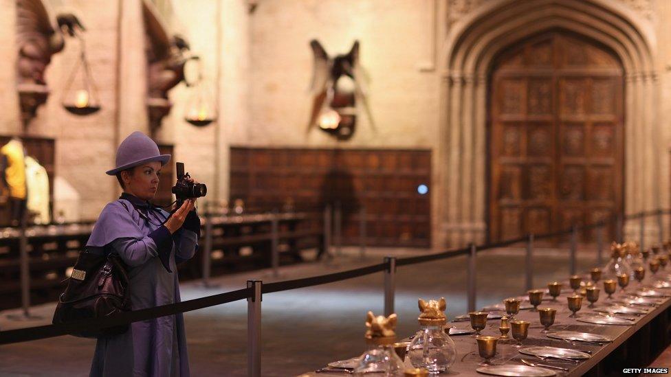 A visitor takes a picture of the Great Hall.