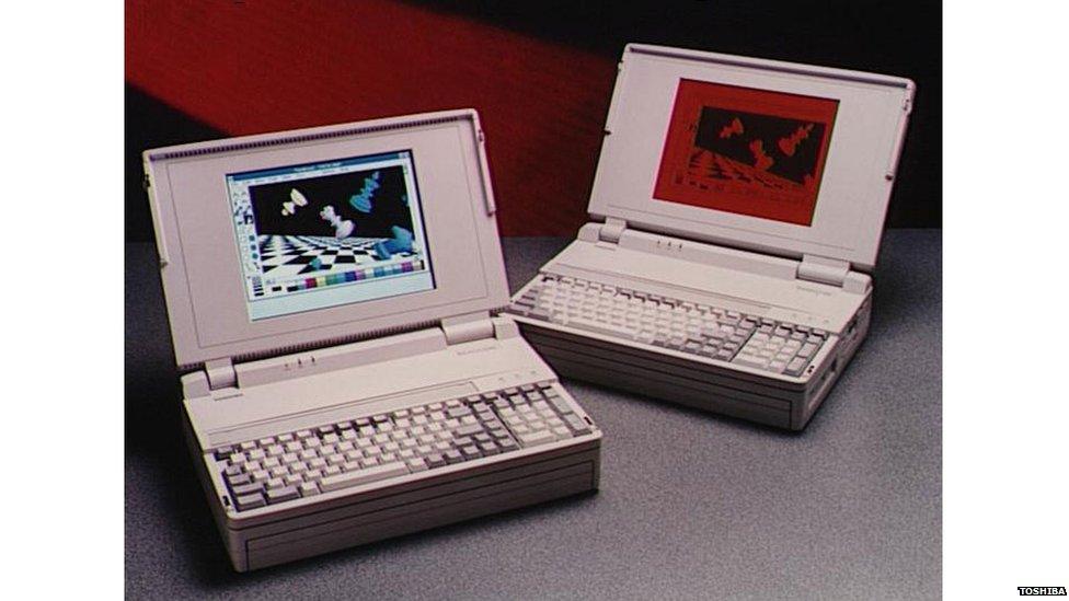 Two archaic Toshiba laptops with very small inset screens. By today's standards, the units are enormous!