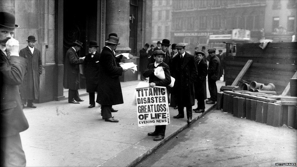 Boy holding newspaper headline about the Titanic disaster