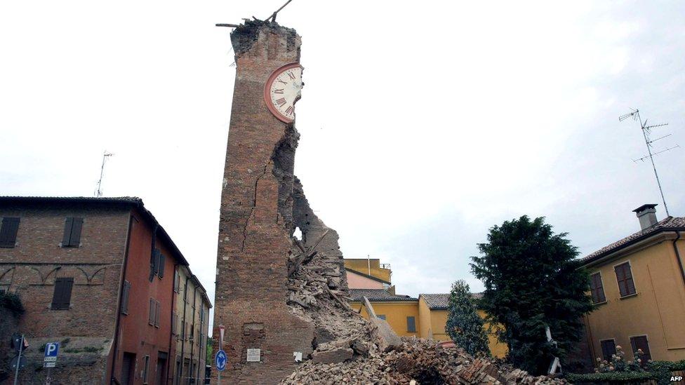 A crumbling clock tower. Half the clock face is still visible.