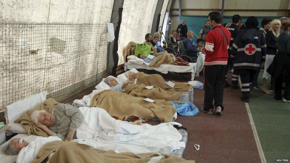 People from a hospital for the elderly receive first aid after an earthquake in Finale Emilia.