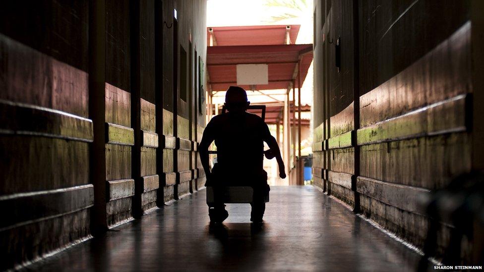 Anibal Rodriguez De Souza, 73, wheels his way down the hallway at the Antonio Aleixo leprosarium on 17 March 2012 in Manaus.