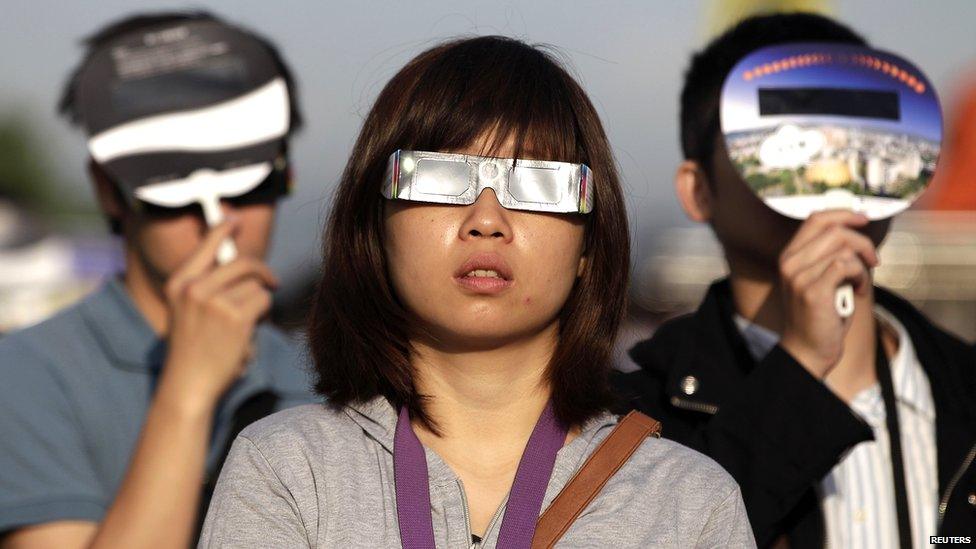 People observe an annular eclipse at Taipei Astronomical Museum.