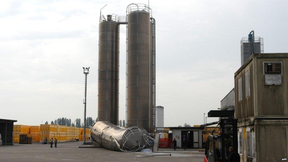 A silo lies on ground in a factory after falling during a earthquake.