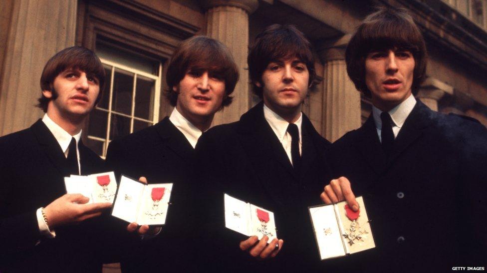 British pop group The Beatles outside Buckingham Palace after receiving their MBEs in 1965.