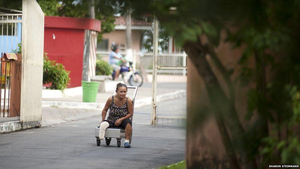 Ira Cema de Souza, 53, goes along the main road to Colonia Antonio Aleixo