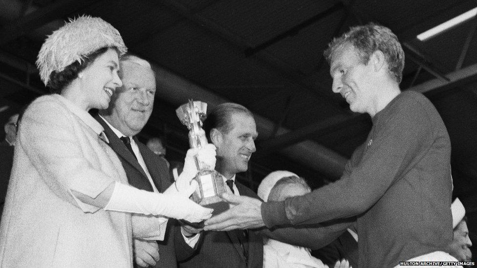 Queen Elizabeth II presenting the Jules Rimet trophy to the England captain, Bobby Moore.