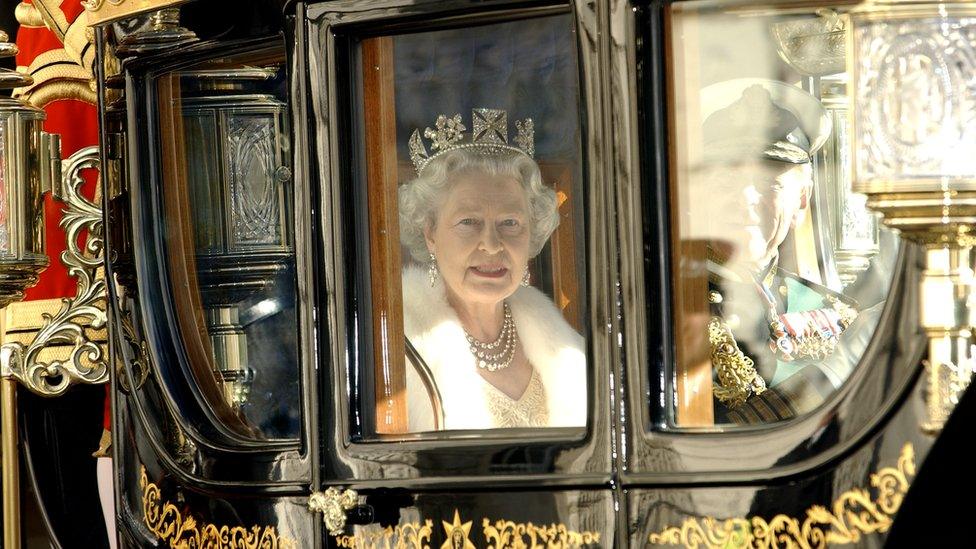 Queen Elizabeth II in a horse drawn carriage on route to the State opening of Parliament