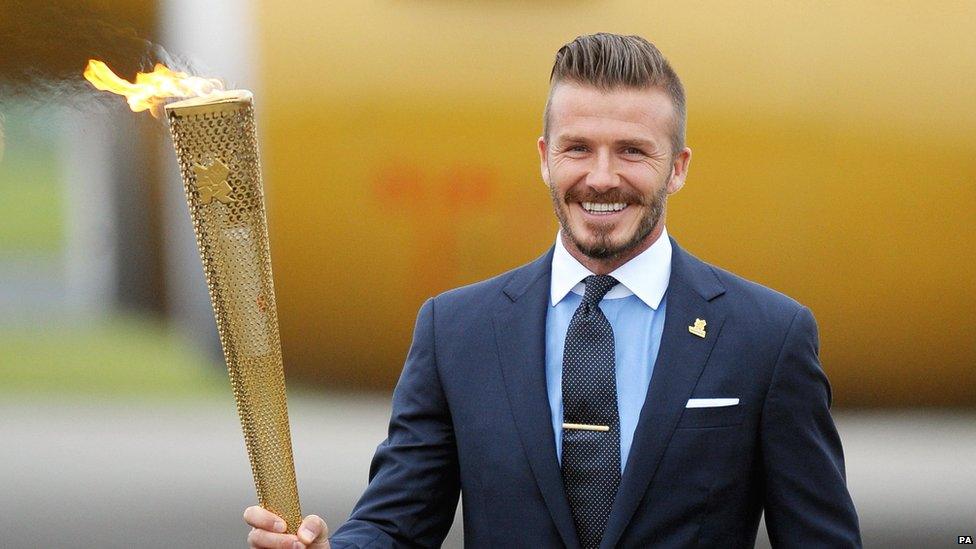 David Beckham with the flame during the ceremony to mark the arrival of the Olympic flame