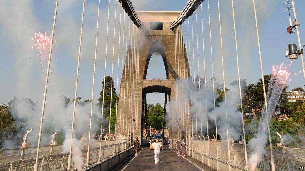 Rebecca Pantaney carrying the Olympic flame over the Clifton Suspension Bridge in Bristol
