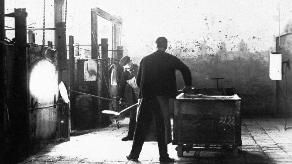 A man tending glass furnaces at Joblings Glassworks, Sunderland. Photo: Beamish Museum