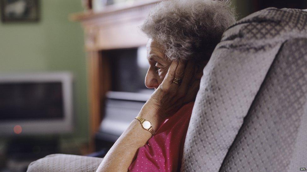 Elderly woman sitting alone