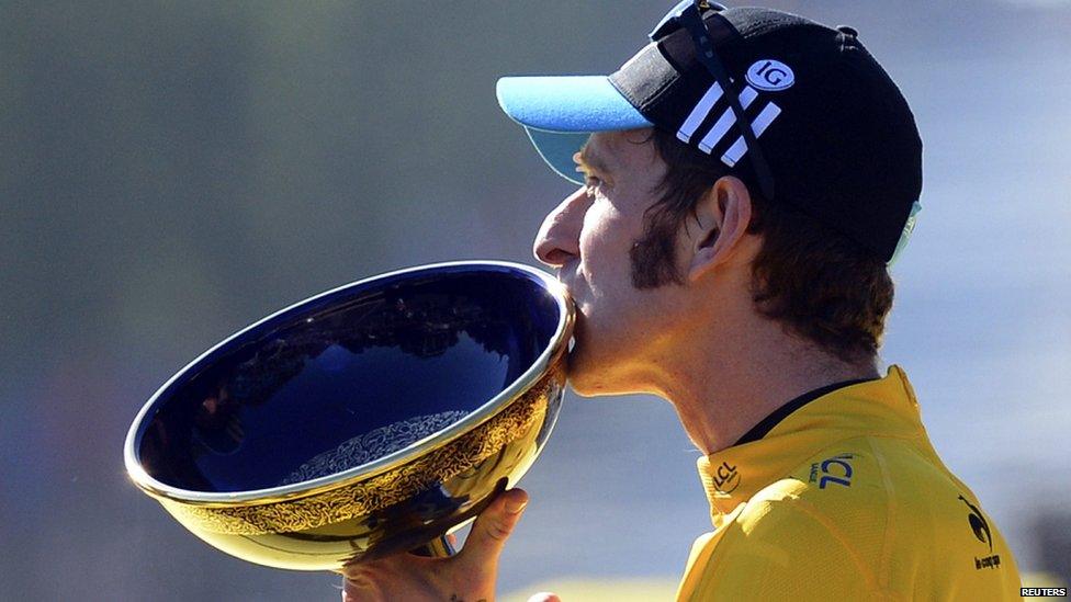 Bradley Wiggins of Britain kisses the trophy as he celebrates his overall victory on the podium after the final 20th stage of the 99th Tour de France cycling race between Rambouillet and Paris, July 22, 2012.