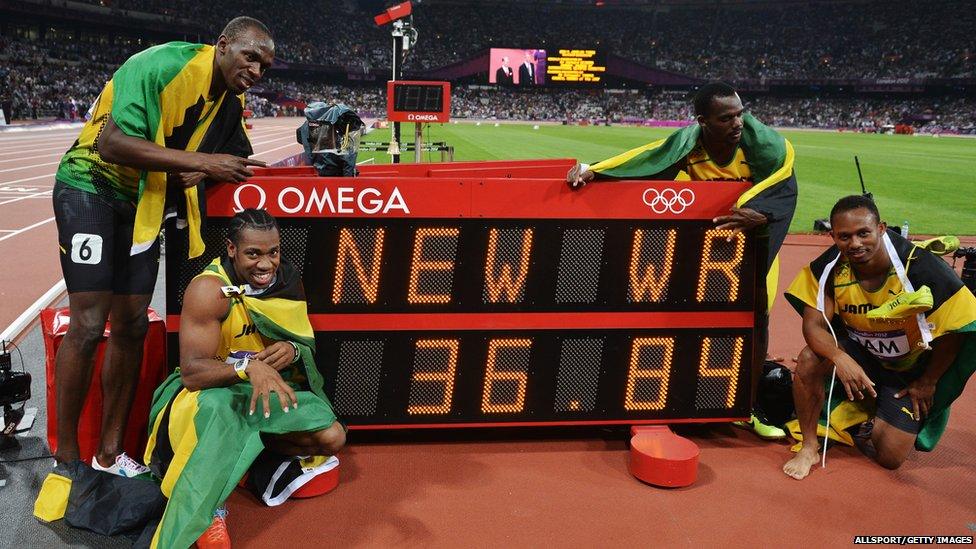 Jamaican 4x100m relay team pose by clock showing their new world record