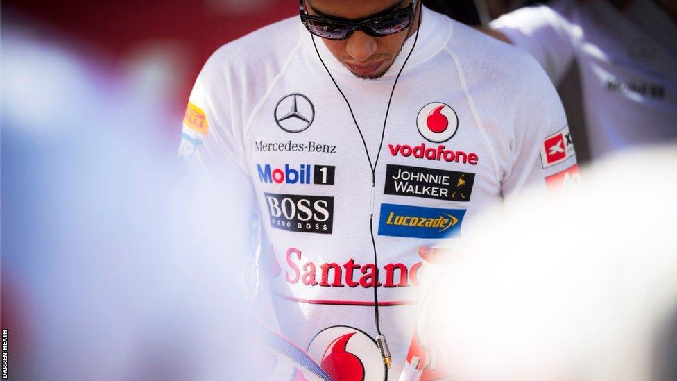 Lewis Hamilton looks lost in thought on the grid preparing for the Belgian Grand Prix