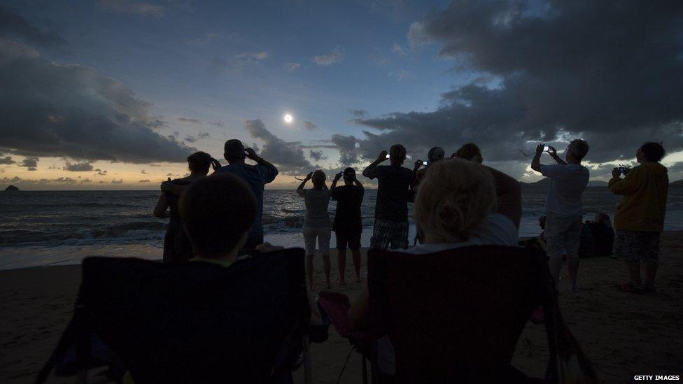 Beach with lots of people viewing the eclipse