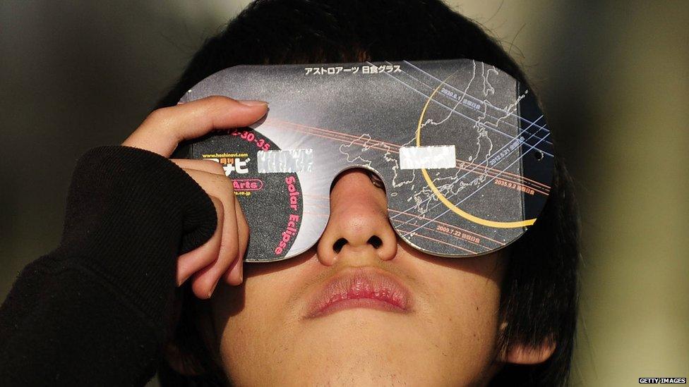 Boy with special glasses to view the eclipse