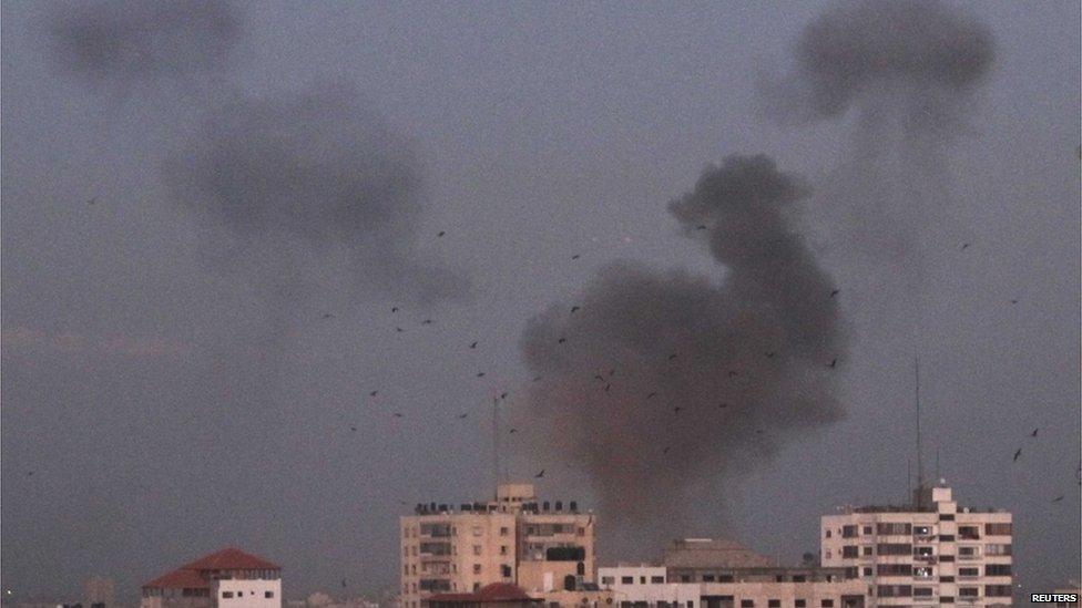 A plume of smoke rises above Gaza City (14 November).