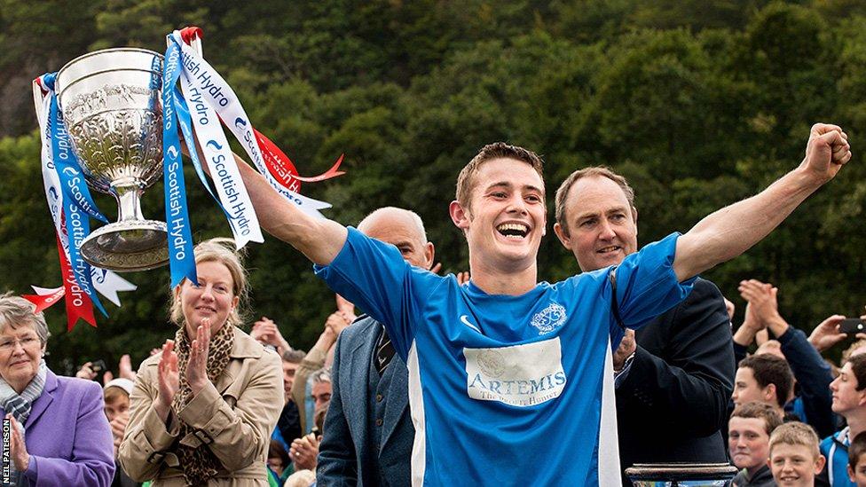 Kyles Athletic captain Andrew King lifts the Camanachd Cup after helping the Tighnabruaich team beat Inveraray in the final at Mossfield Park, Oban