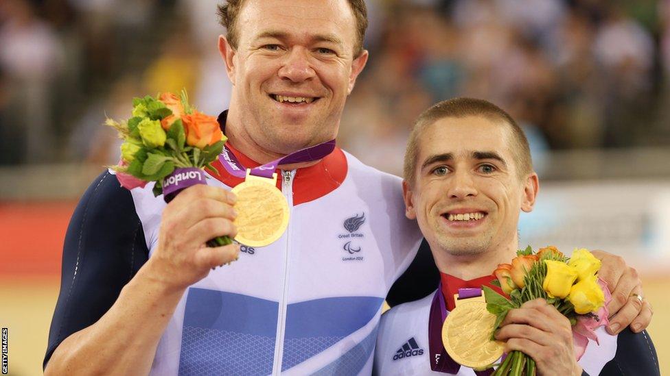 Pilot Barney Storey and Neil Fachie pose with their gold medals