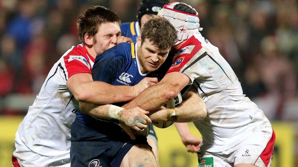 Leinster's Gordon D'Arcy attempts to force his way through the challenges of Ulster forwards Rory Best and Iain Henderson