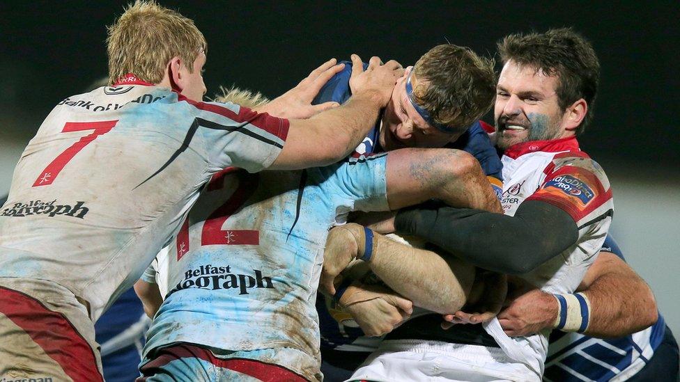 Leinster's Jamie Heaslip tackled by Jared Payne, Luke Marshall and Chris Henry of Ulster