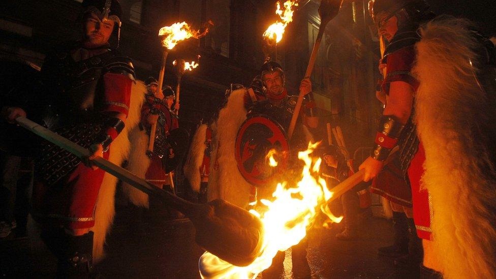 People take part in a torchlight procession through Edinburgh as part of the pre Hogmanay celebrations.