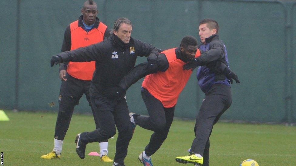 Mario Balotelli (far left) and Roberto Mancini (second left)