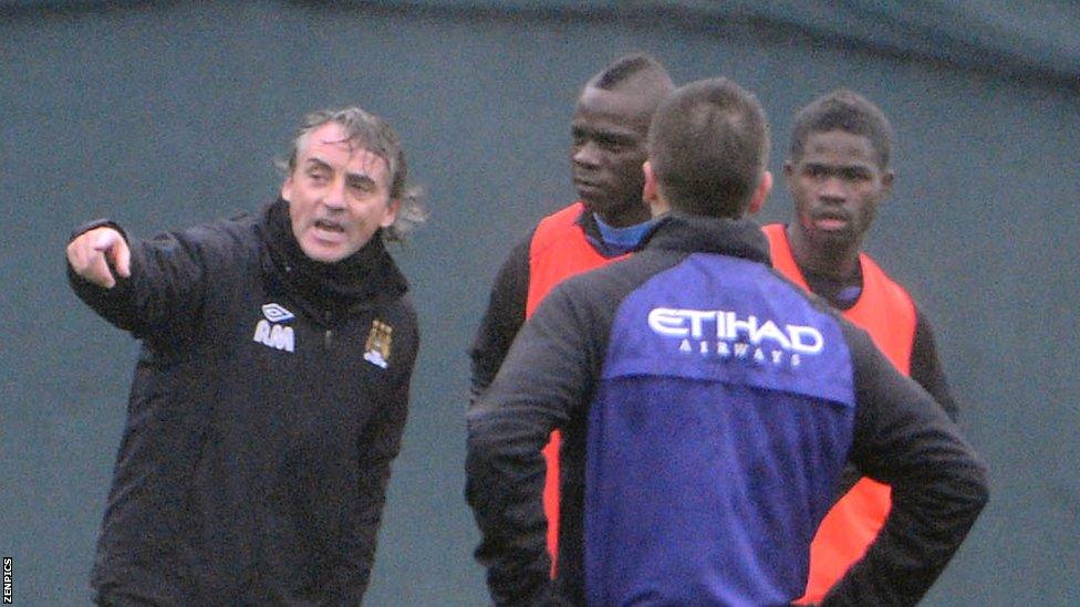 Roberto Mancini (far left) and Mario Balotelli (second from left)