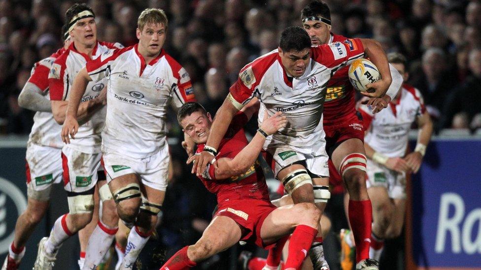 Tavis Knoyle of Scarlets attempts to halt a powerful charge by Ulster number eight Nick Williams at Ravenhill